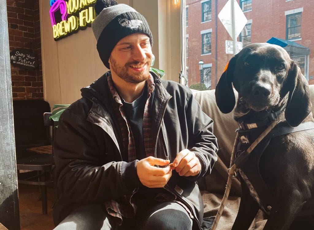 pup at brew'd awakening enjoying a peanut butter treat